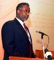 Professor Osman Mahgoub speaking at a lectern.